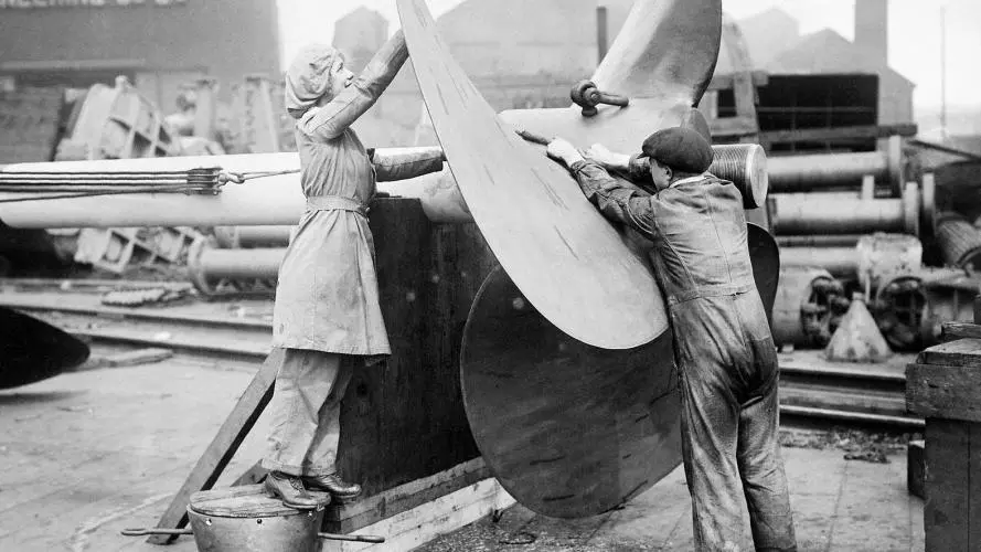 A female worker assists with the alignment of a ship's propeller on Tyneside