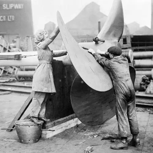 A female worker assists with the alignment of a ship's propeller on Tyneside