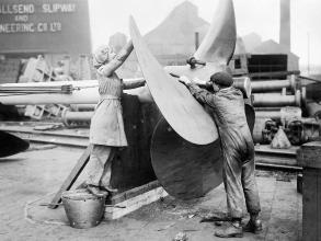 A female worker assists with the alignment of a ship's propeller on Tyneside